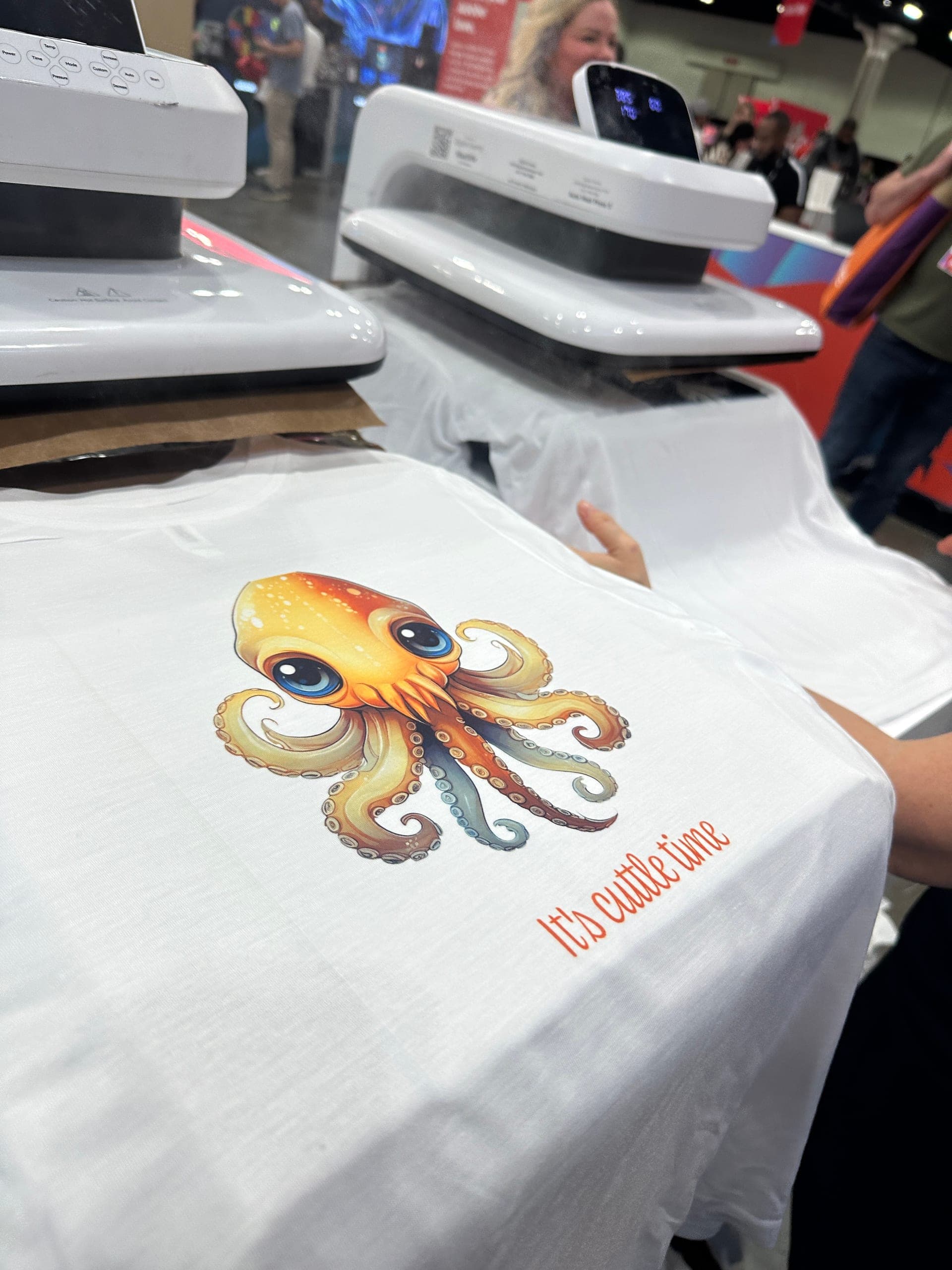 Custom apparel being produced with heat press equipment