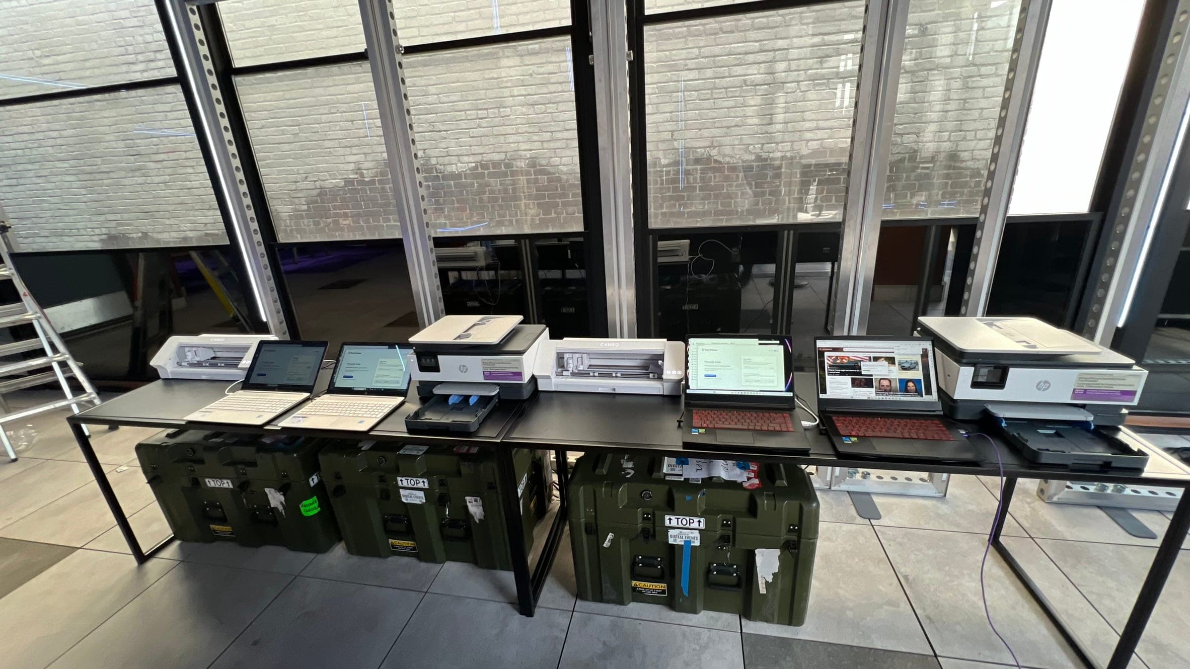 Event production workflow station with equipment and laptops