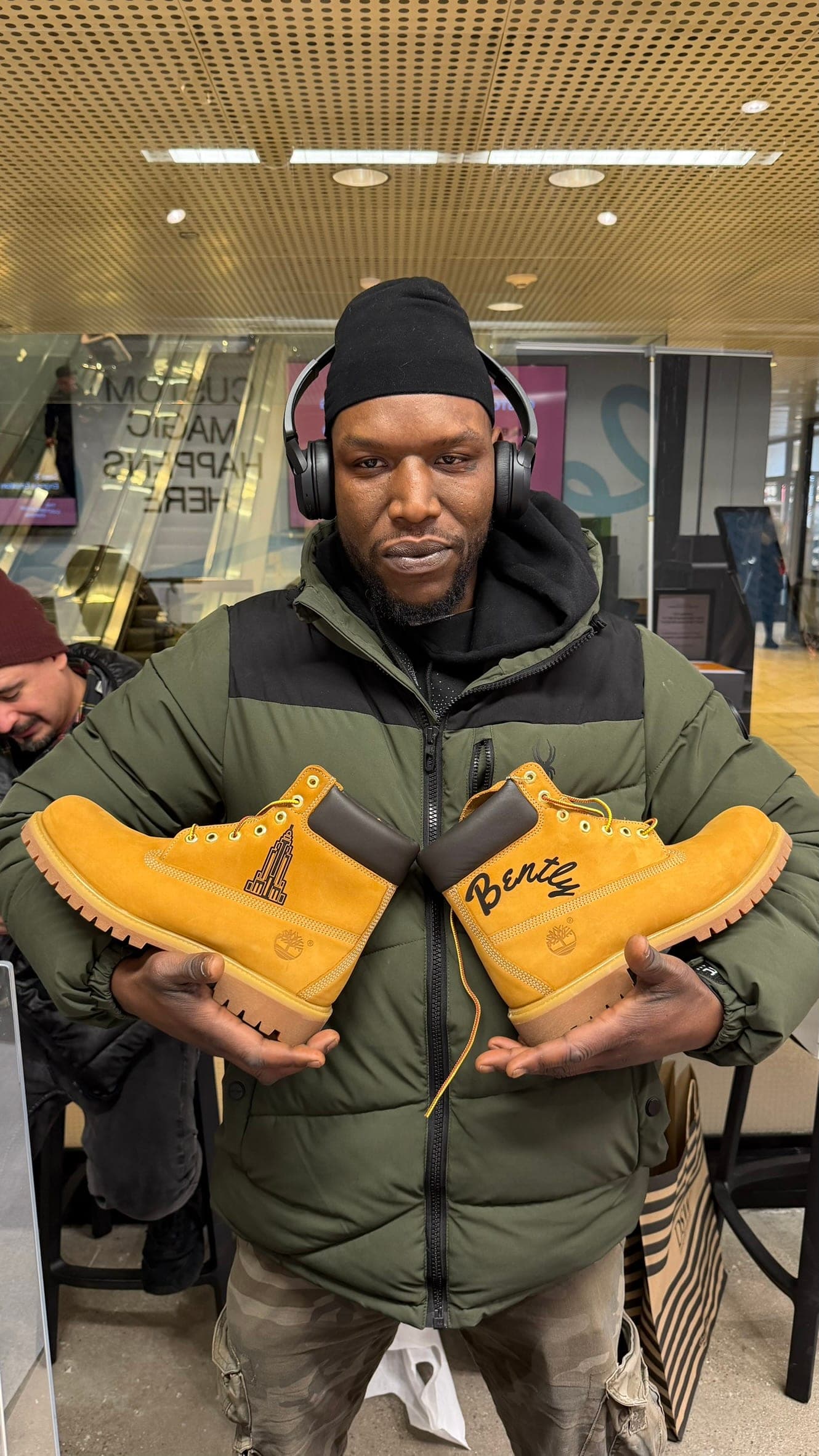 Guest holding personalized engraved boots at a live event